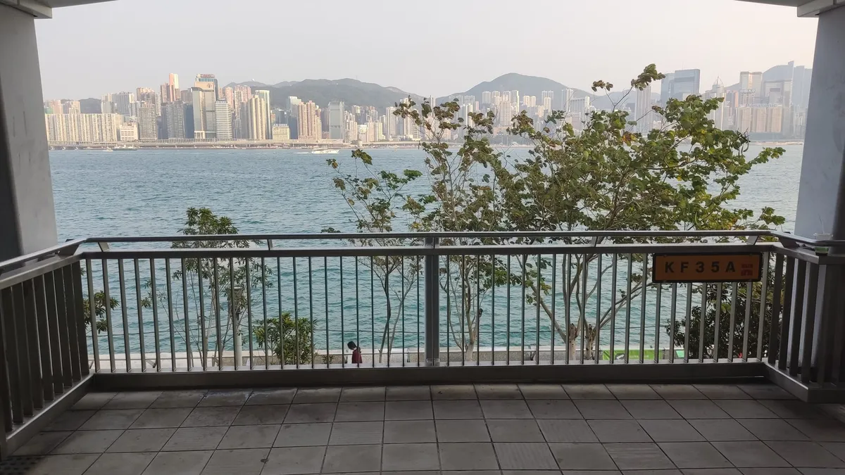A covered viewing point on the promenade looking across the harbour