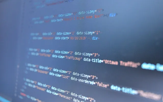 Web page code blurred on a dark blue screen